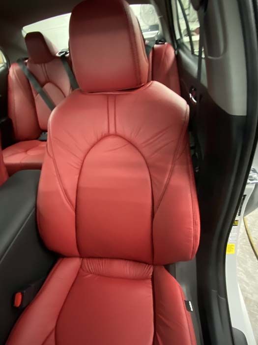 Red leather car seats inside a vehicle.