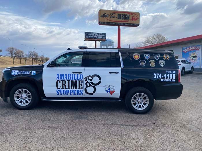 Amarillo Crime Stoppers SUV, black and white, with a handcuff graphic and organization logos.