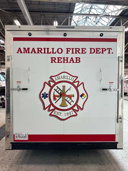 Rear of Amarillo Fire Dept. Rehab truck with logo and red accents.