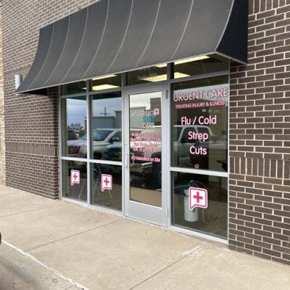 Urgent care clinic entrance with awning. Services advertised: Flu/Cold, Strep, Cuts.