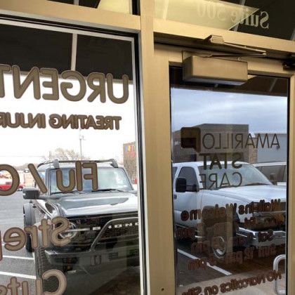 Two cars parked near a building with 