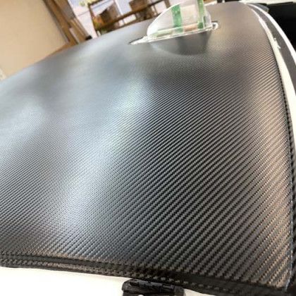 Black carbon fiber textured surface.