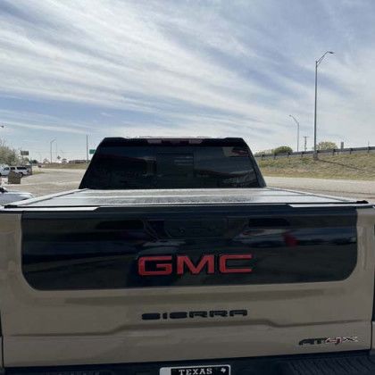 Tan GMC Sierra truck with black accents, red 