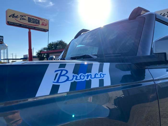Dark blue Bronco SUV with custom hood stripes and 