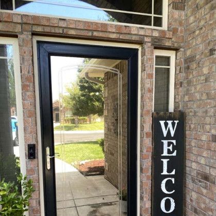 Black front door with a screen door, 