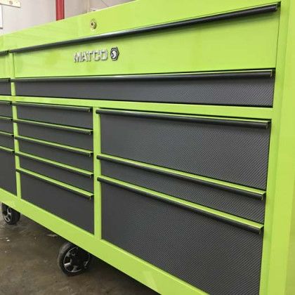 Green Matco tool chest with black drawer fronts and handles, on wheels.