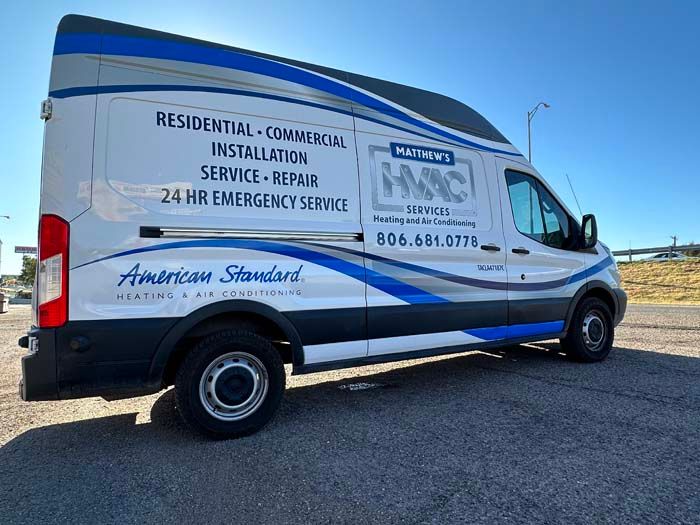 White HVAC service van with blue and gray accents; American Standard branding.