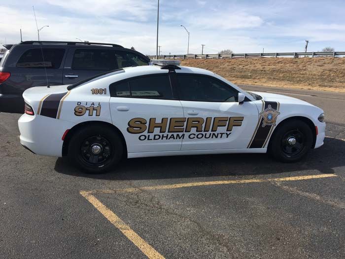White Oldham County Sheriff car parked in a lot.