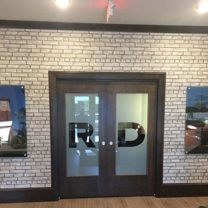 Brick wall with a dark wooden double door with 