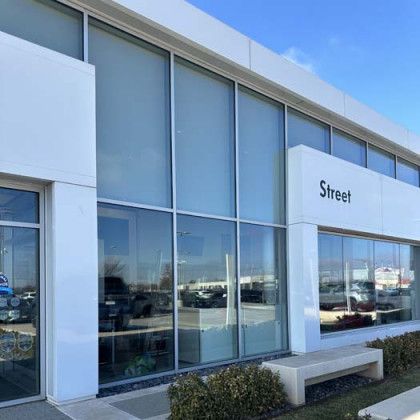 White building with large windows; 