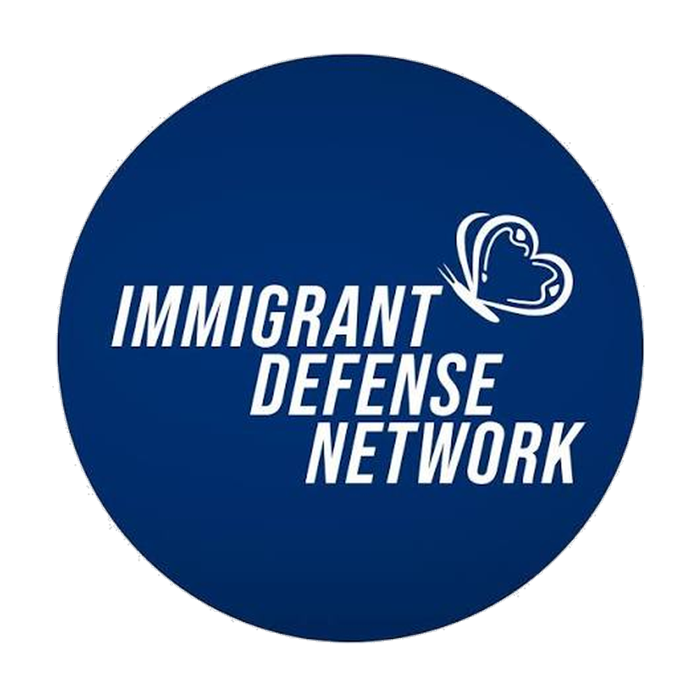 Blue circular logo reading “Immigrant Defense Network” with a white heart outline icon
