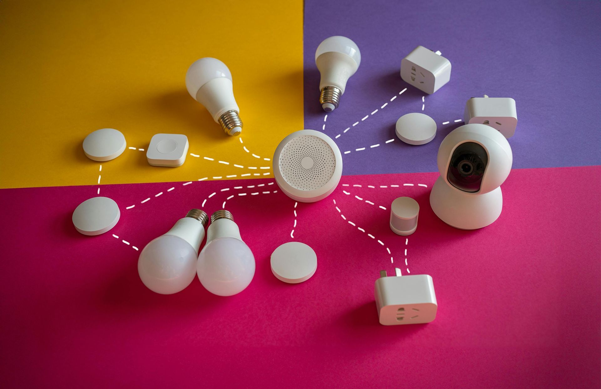 Assorted smart light bulbs arranged around a central hub on a pink and purple background.