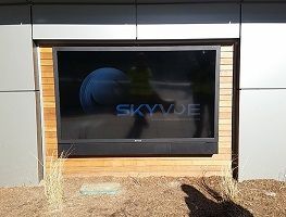 SkyVue digital sign in a black frame on a modern building exterior.