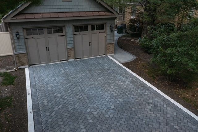 An aerial view of a garage with a driveway leading to it.