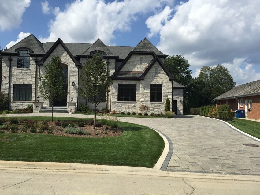 A large house with a large driveway in front of it