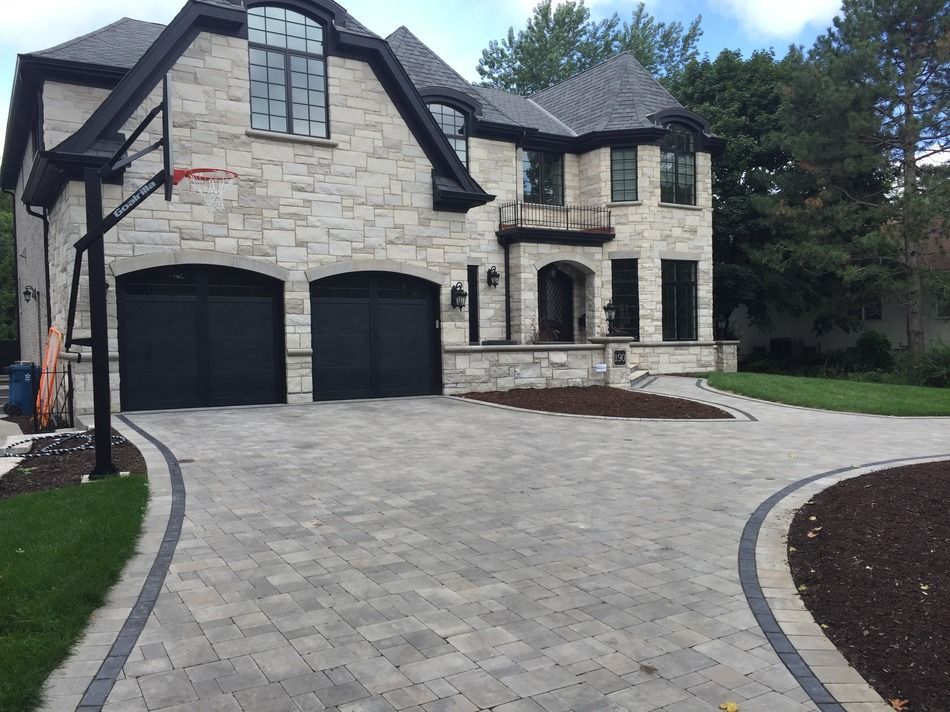 A large house with a basketball hoop in front of it.