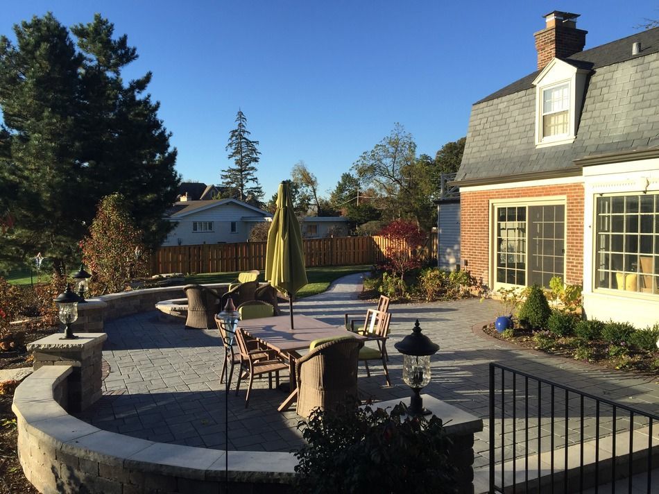 A large brick house with a patio in front of it