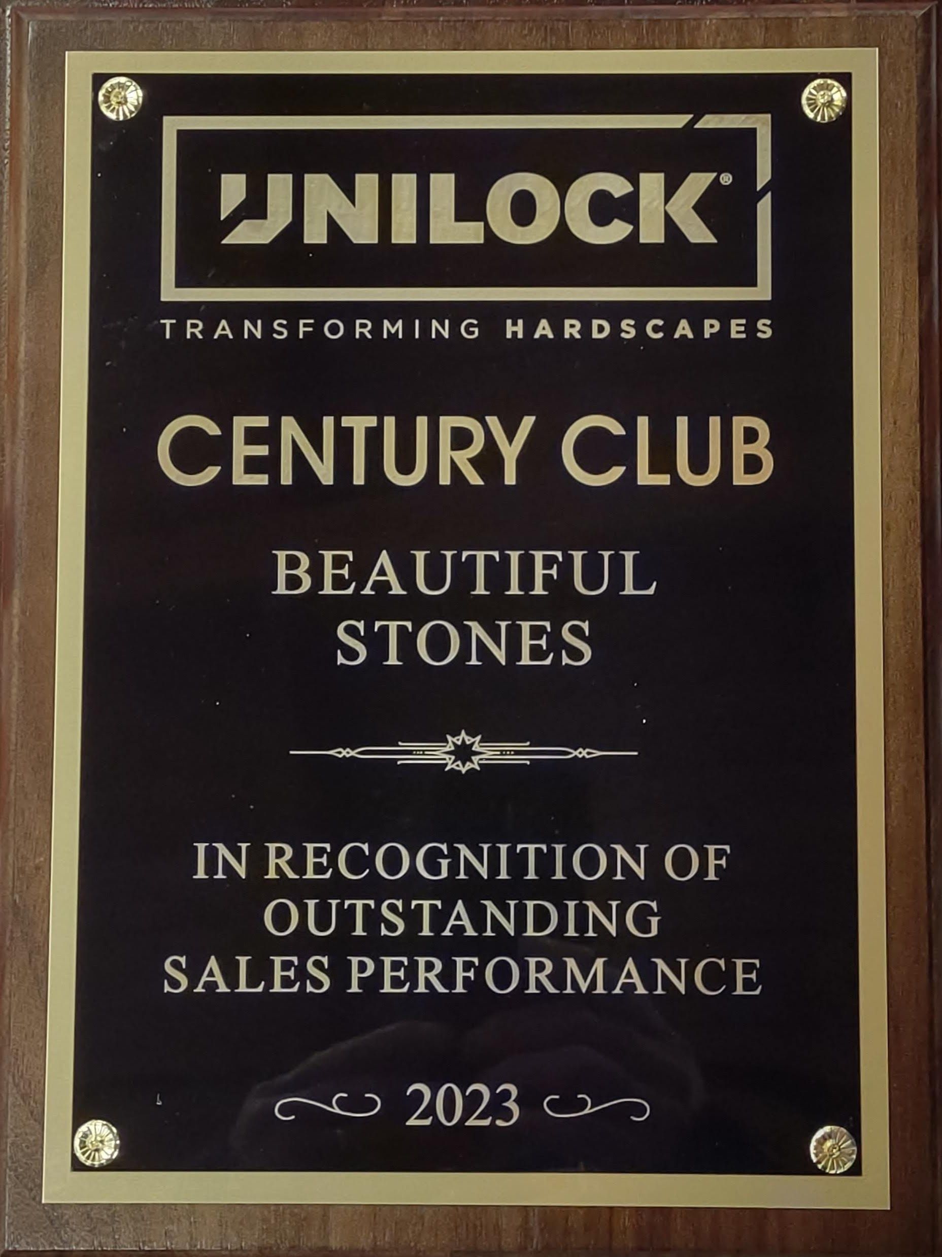A plaque that says century club beautiful stones in recognition of outstanding sales performance