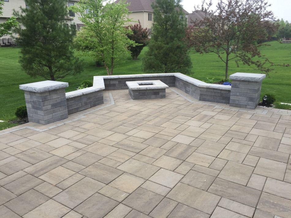 There is a fire pit in the middle of the patio.