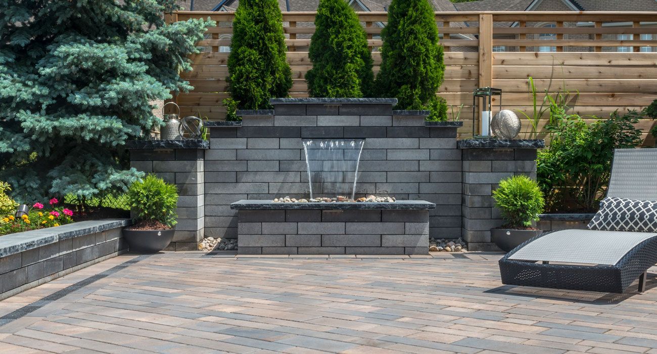 There is a waterfall in the middle of the patio.
