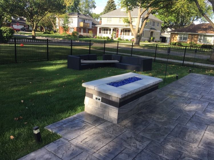 There is a fire pit in the middle of the yard.