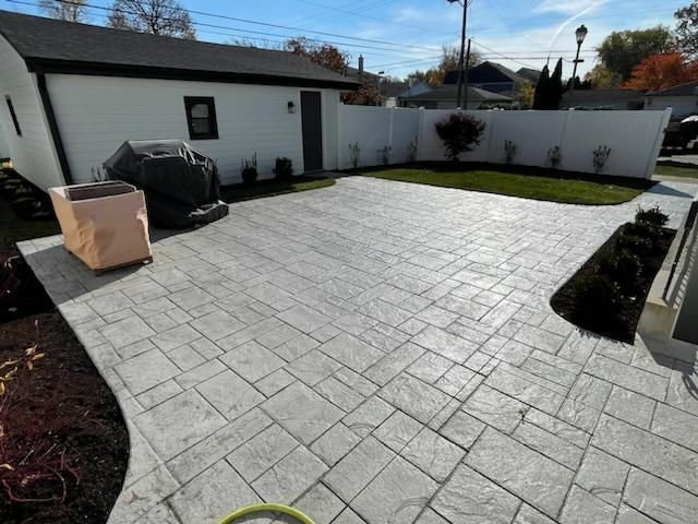 A white house with a concrete driveway in front of it