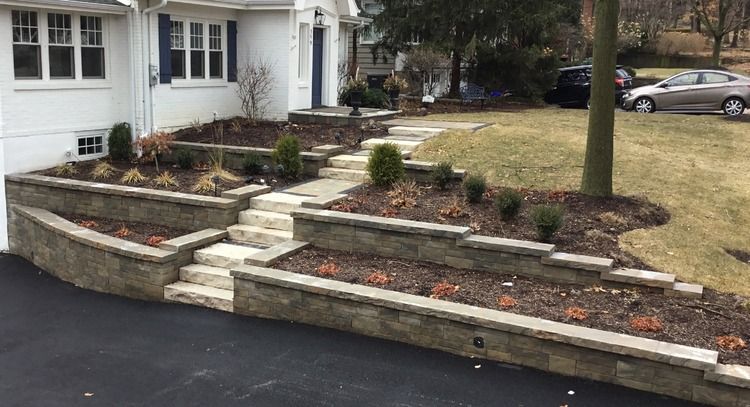 A white house with a stone walkway leading to the front door.