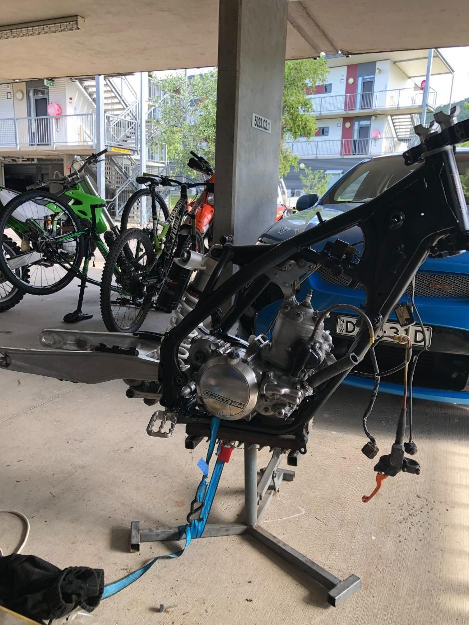 Dirt Bike Frame on a Stand, Engine Installed, Blue Straps — Bodes All Mechanical In Tantawangalo, NSW