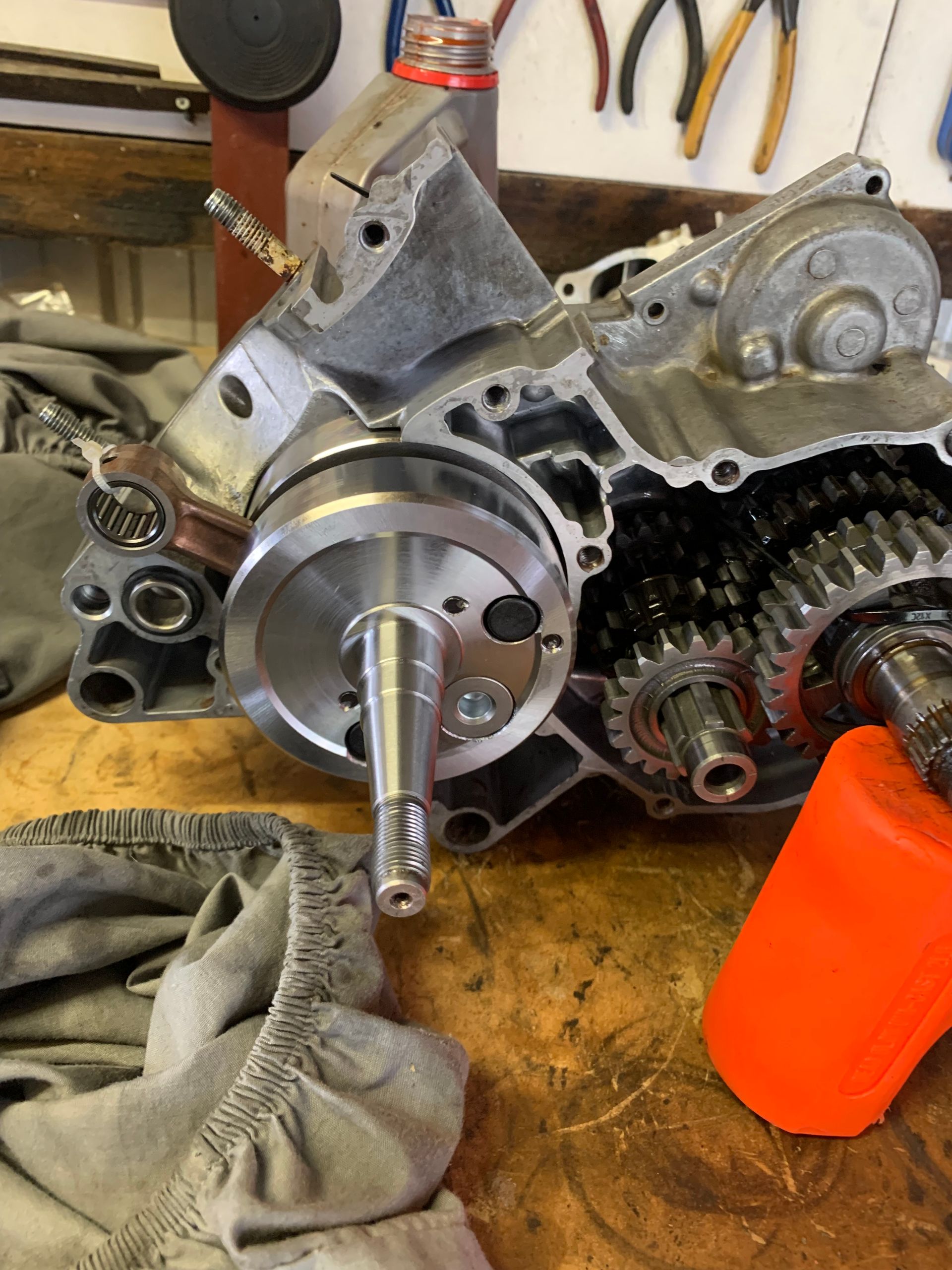 Motorcycle engine block open on workbench, with crankshaft and gears visible. — Bodes All Mechanical In Eden, NSW
