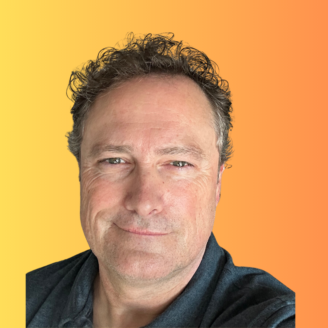 Close-up portrait of a person against a yellow-to-orange gradient background, wearing a dark shirt, with a slight smile