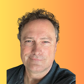 Close-up portrait of a person against a yellow-to-orange gradient background, wearing a dark shirt, with a slight smile