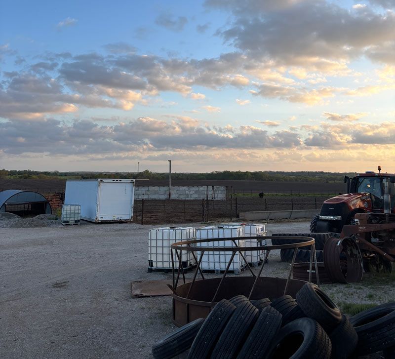 sunset in kansas with tractor and additional farm and conservation tools