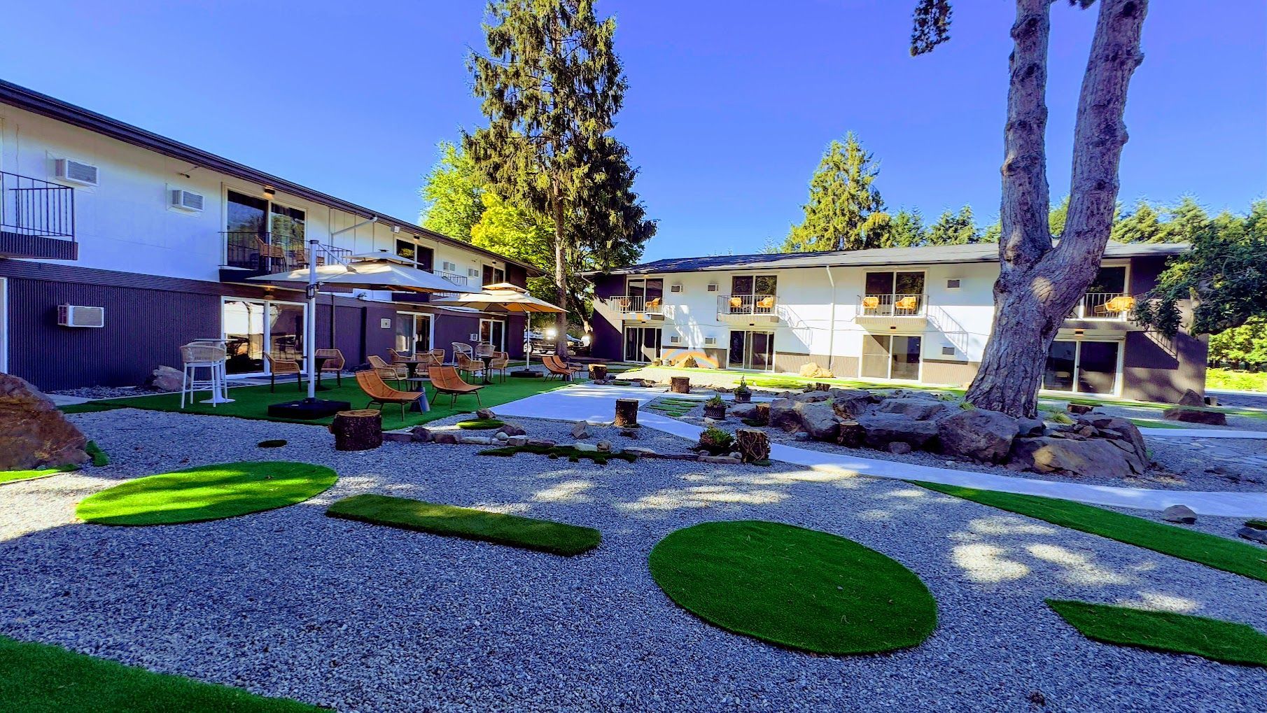 A large house with a lush green yard in front of it.