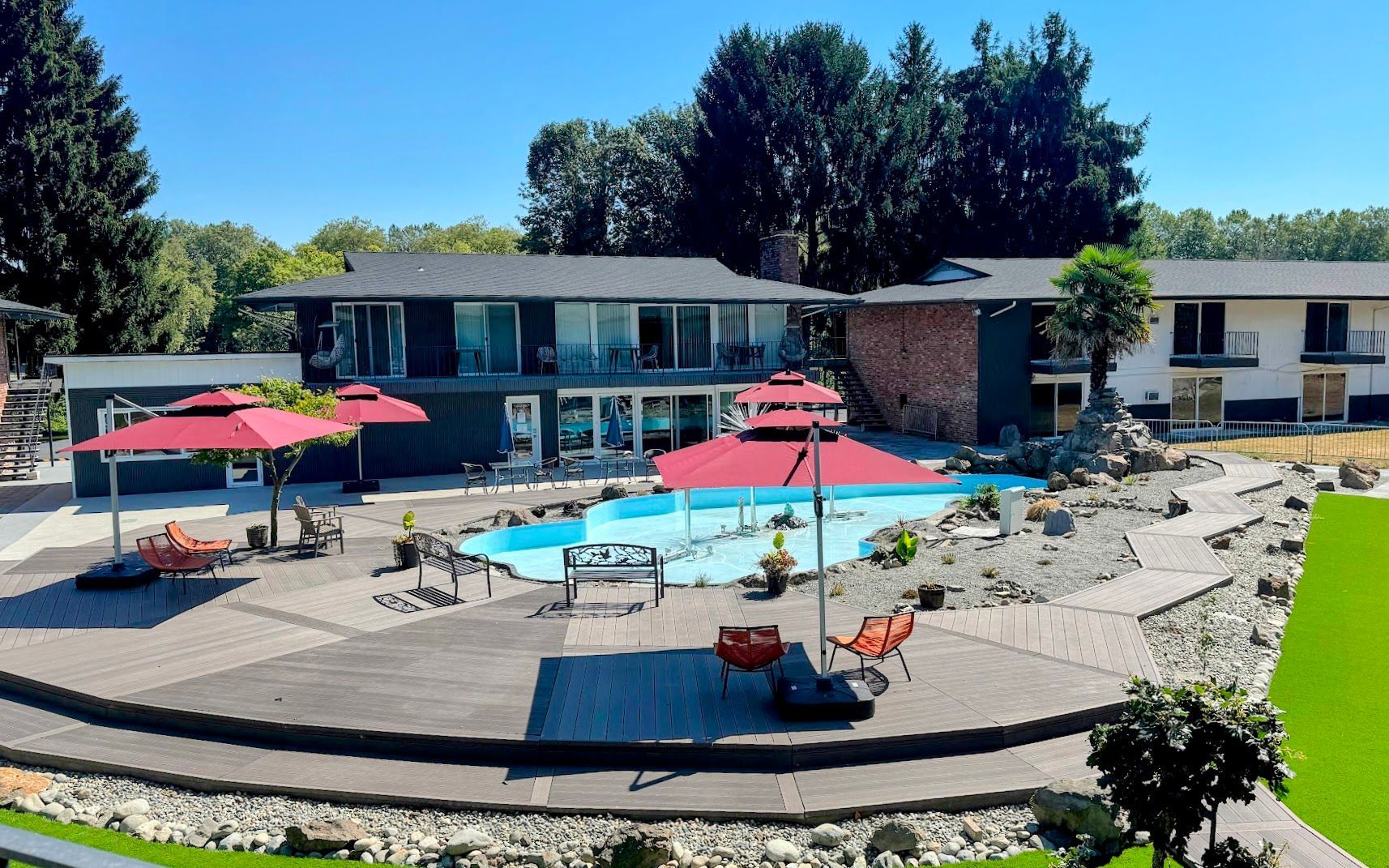 A large house with a swimming pool in front of it