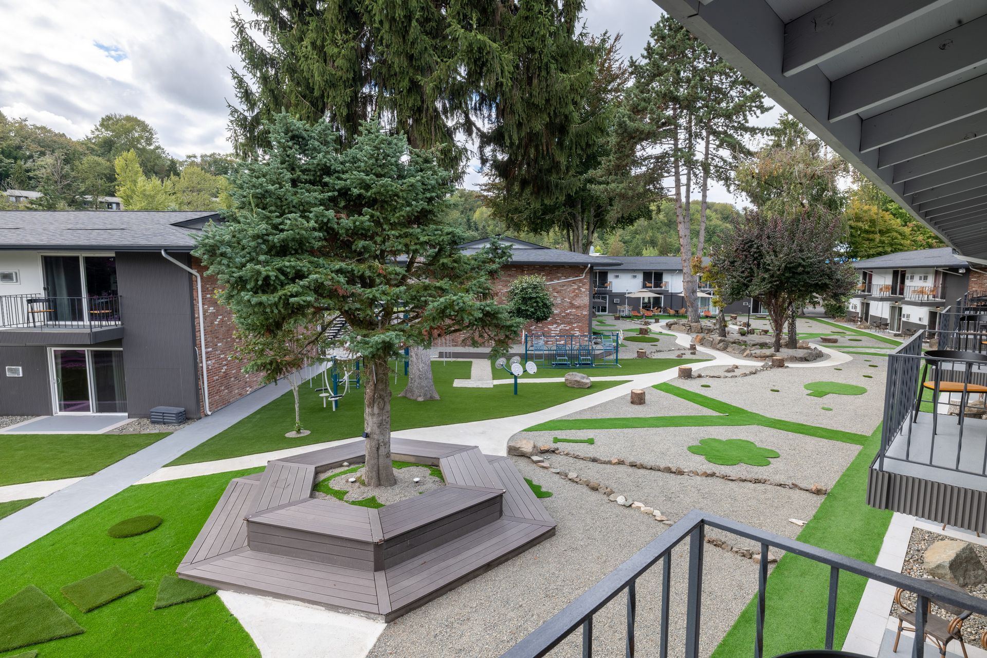 A view of a lush green courtyard from a balcony.