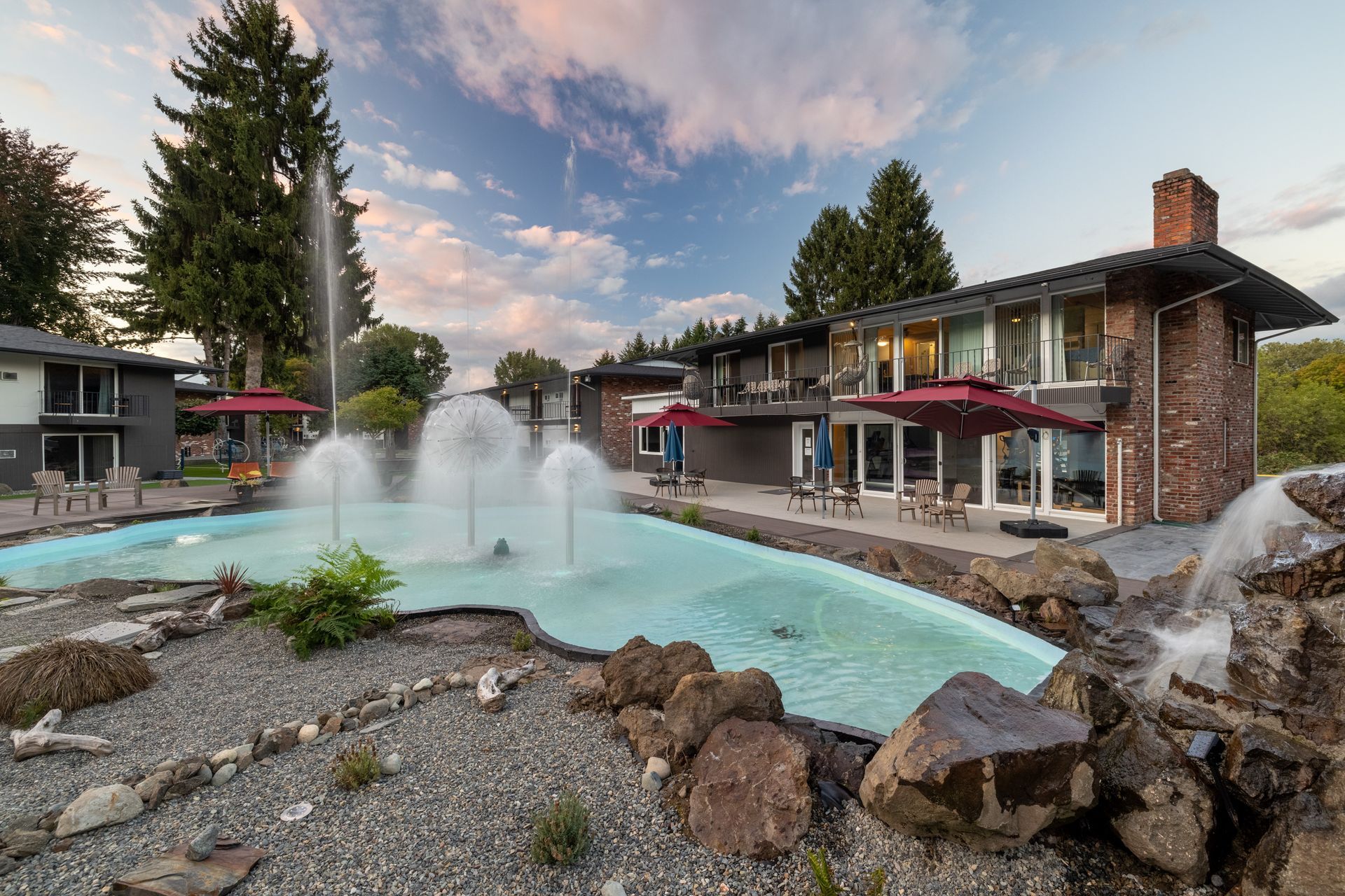 A large house with a fountain in front of it.