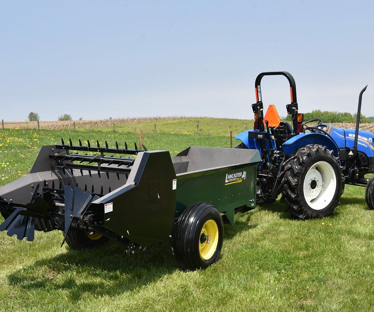 a blue tractor with a trailer attached to it