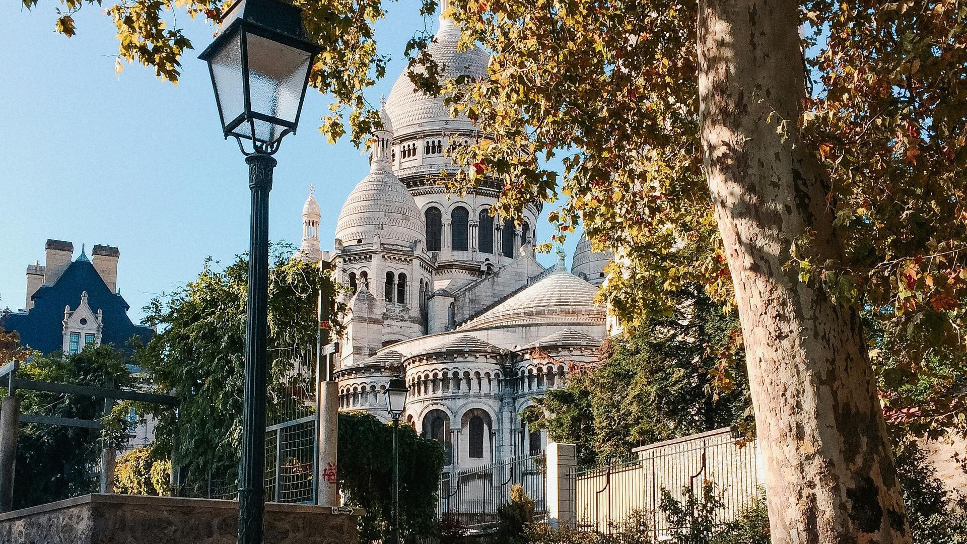 Sacré-Coeur Basilica from the distance in Montmartre district in Paris with a local guide