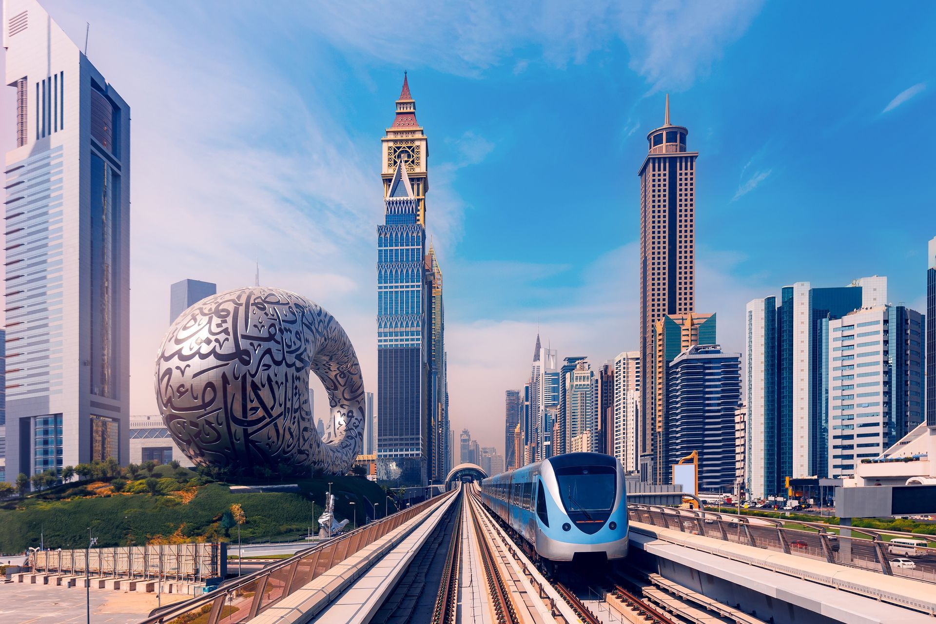 A modern train travels through Dubai, passing skyscrapers and the Museum of the Future.