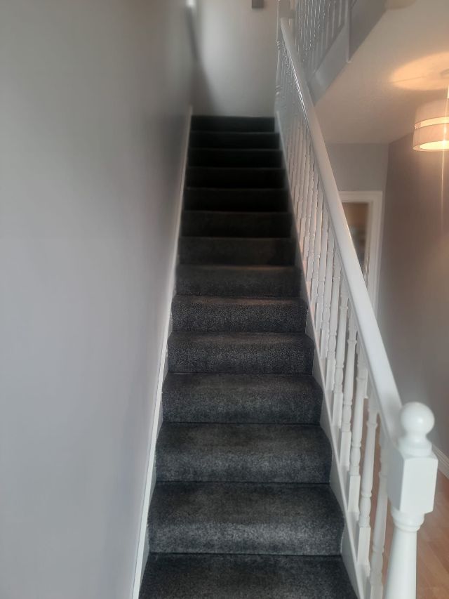 A black staircase leading up to the second floor of a building