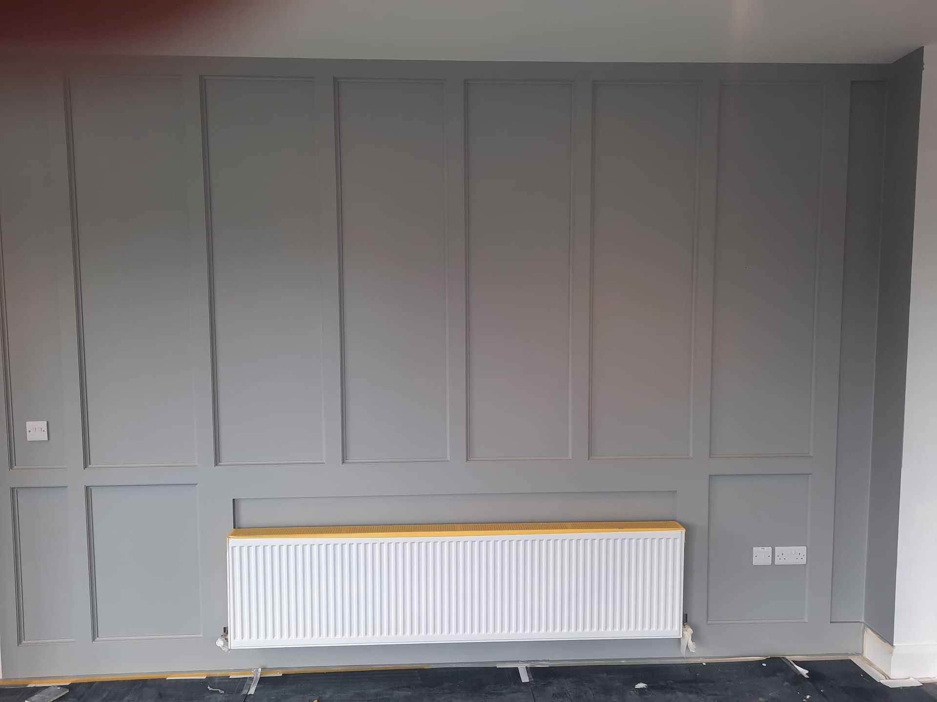 A room with a radiator on the wall.