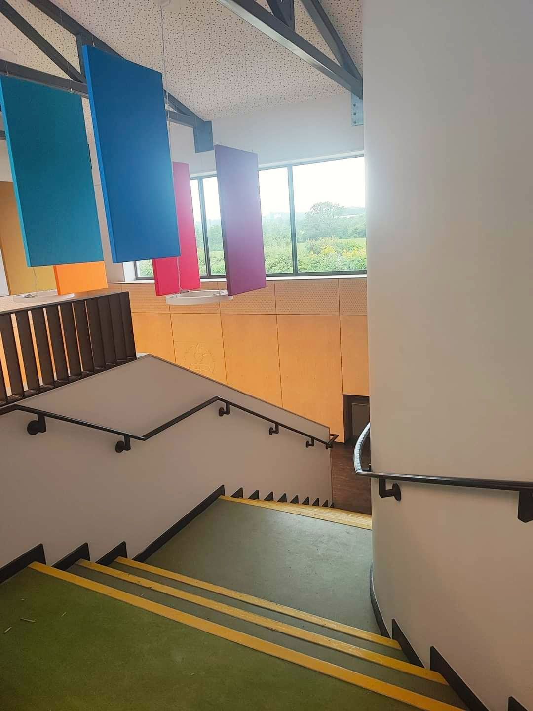 A set of stairs leading up to a window in a building