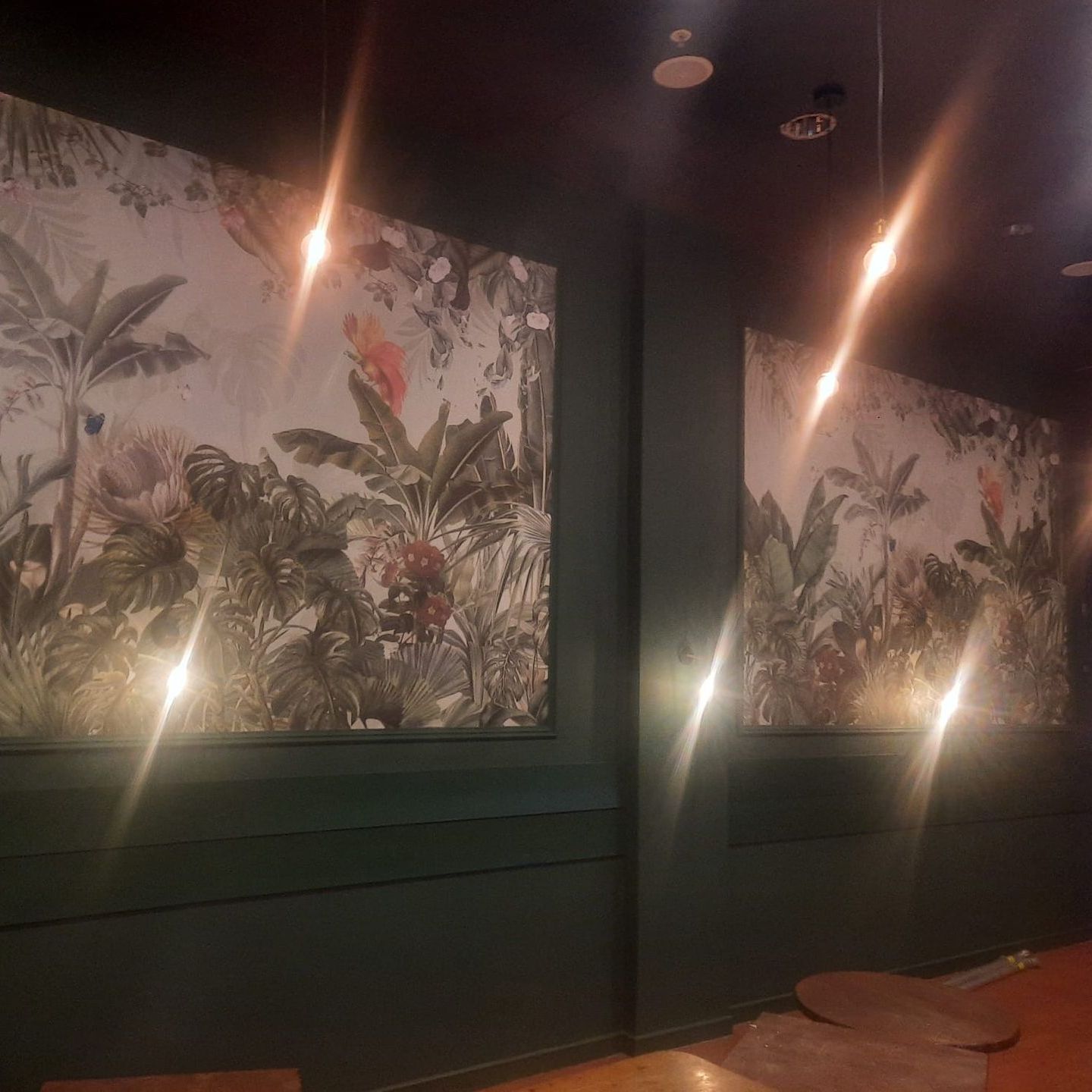 A room with a lot of paintings on the wall.