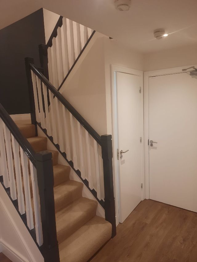 A black staircase leading up to the second floor of a building