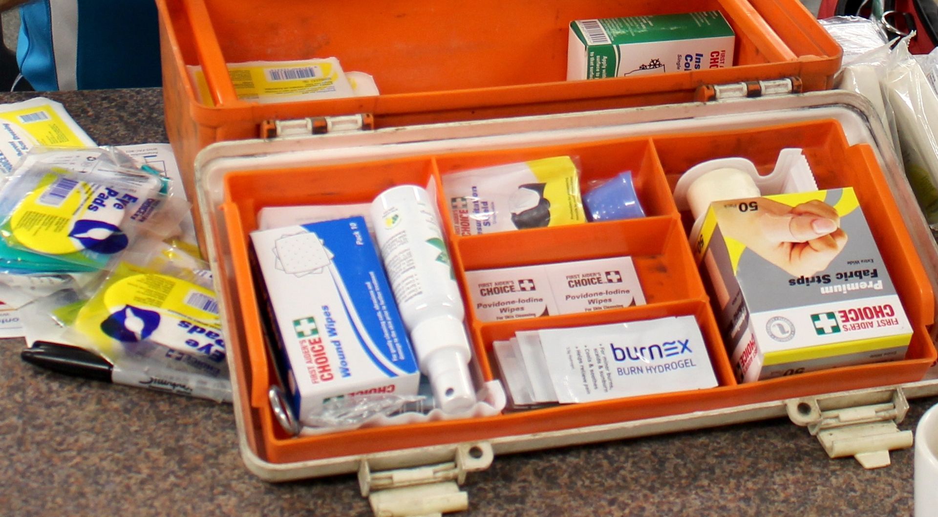 A First Aid Kit Is Sitting On A Table  —  Accidental Health & Safety NQ & Mt Isa In Longreach, QLD