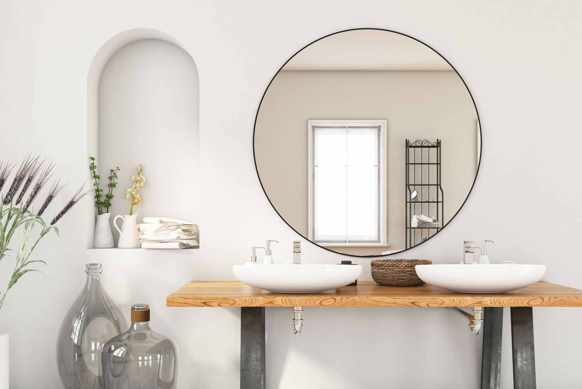 A bathroom with two sinks and a round mirror. A bathroom with two sinks and a round mirror.