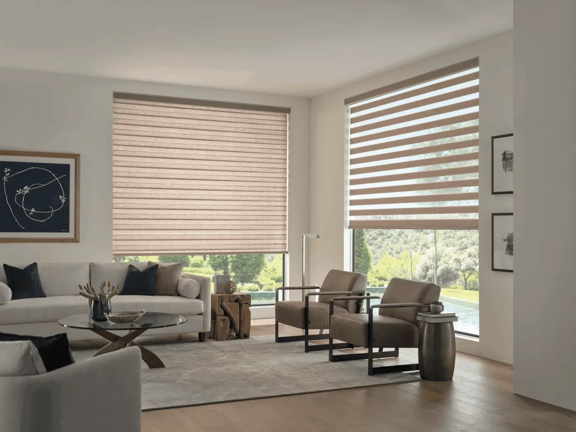 Bright living room with large windows, beige blinds, sofa, chairs, and a coffee table.