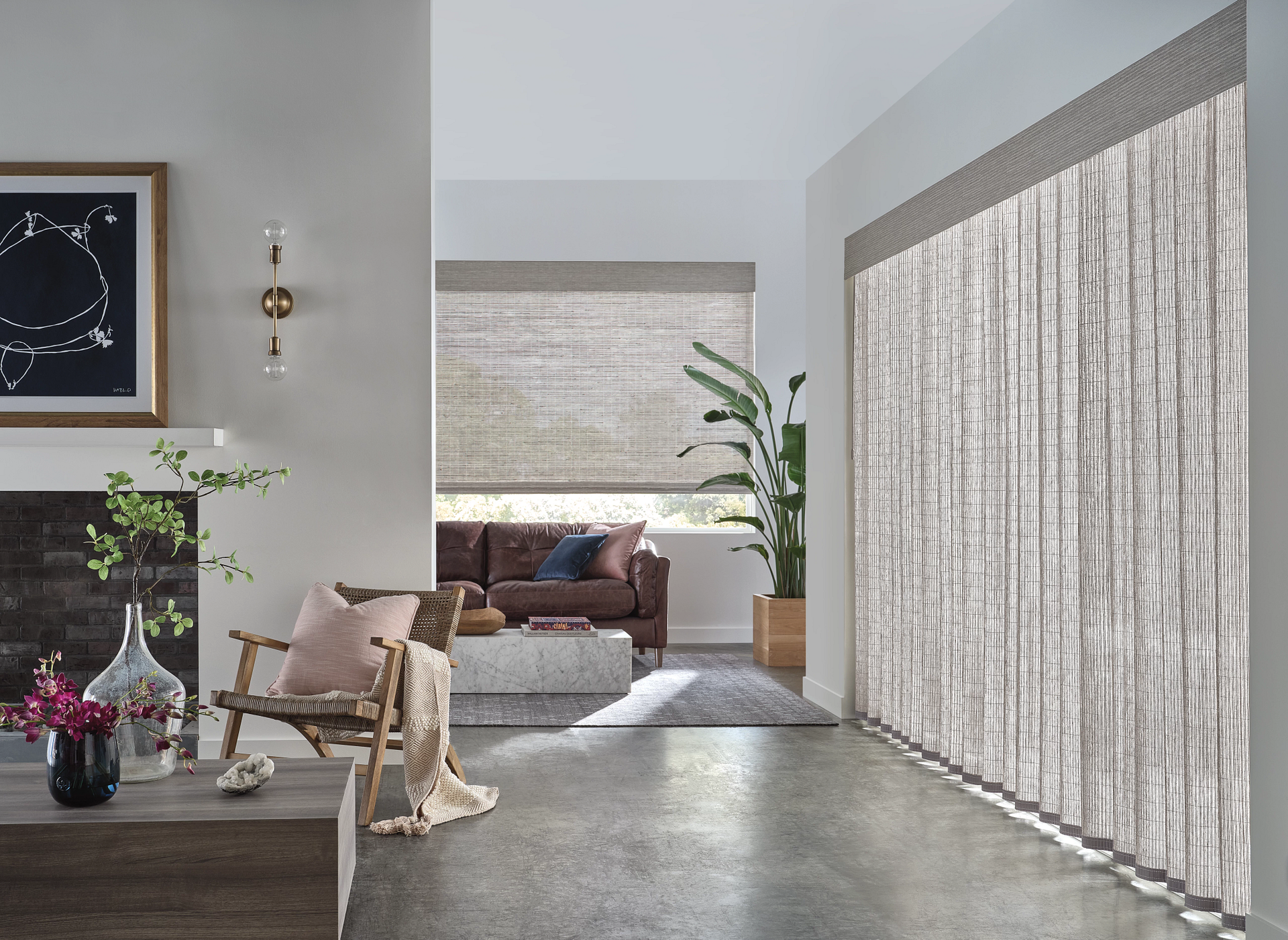 Modern living room with sheer curtains, sofa, fireplace, and a small dining table with flowers