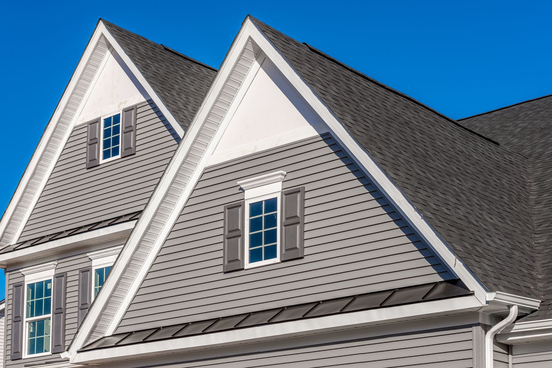 Two gabled peaks with window elements and exterior shutters