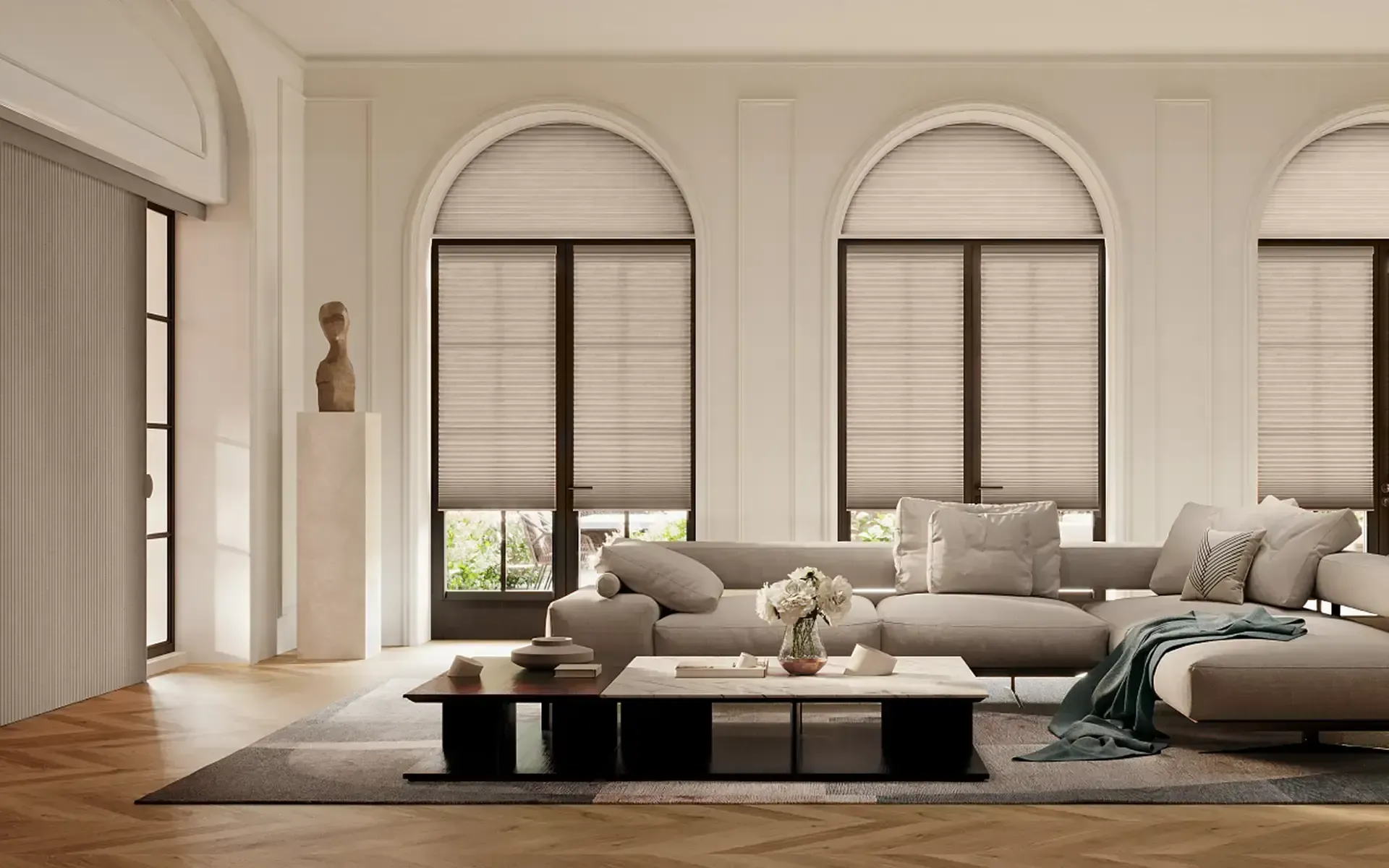 Bright modern living room with arched windows, beige sofas, and a black coffee table